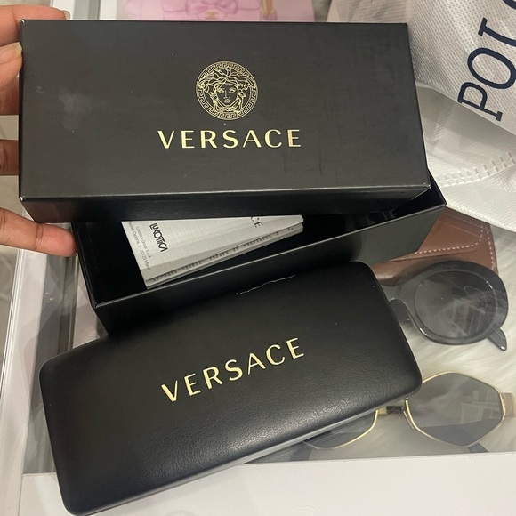 Beautiful  Versace Sunglasses feature mirrored silver lenses and gold rim.